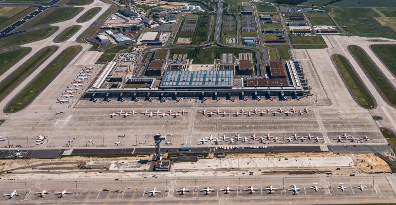 Luftaufnahme Flughafen Berlin Brandenburg Luftaufnahme eines großen Flughafens mit Start- und Landebahnen sowie Parkplätzen.